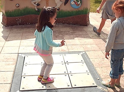 a child stepping on the musical steps at the sensory playground